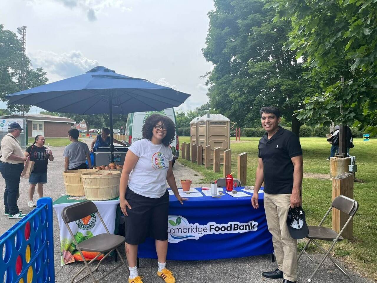 Nazim Shah meeting a Cambridge Food Bank team member at a local community event